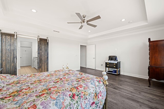 6633 Penfield St, Wake Forest, NC 27587 - bedroom with a tray ceiling, a barn door, wood finished floors, recessed lighting, and ornamental molding