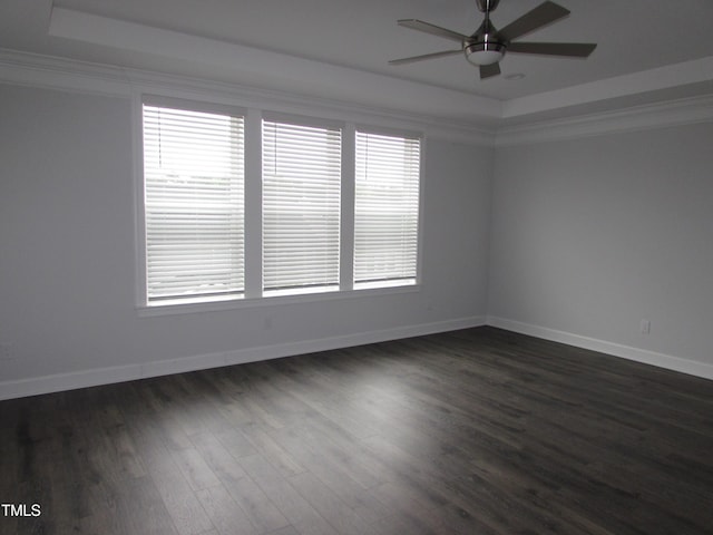 6633 Penfield St, Wake Forest, NC 27587 - spare room featuring a tray ceiling, a ceiling fan, dark wood-style flooring, ornamental molding, and baseboards