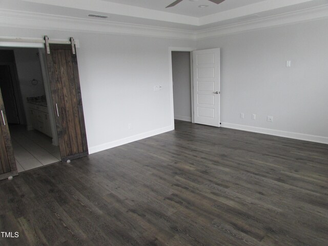 6633 Penfield St, Wake Forest, NC 27587 - unfurnished room with ornamental molding, dark wood-type flooring, ceiling fan, baseboards, and a barn door
