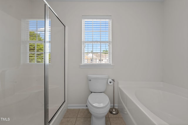 604 Oakfield Trl, Mebane, NC 27302 - full bathroom featuring a bath, tile patterned flooring, a shower stall, baseboards, and toilet