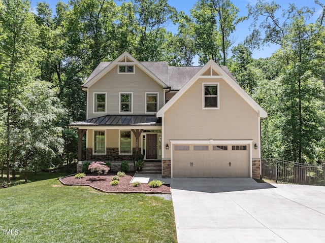 craftsman-style home featuring a garage, a front yard, concrete driveway, a standing seam roof, and covered porch