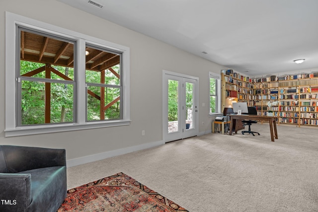 carpeted home office with baseboards and visible vents