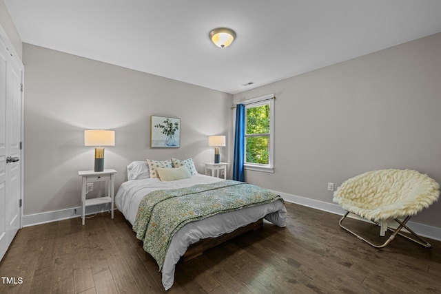 bedroom featuring baseboards and hardwood / wood-style floors