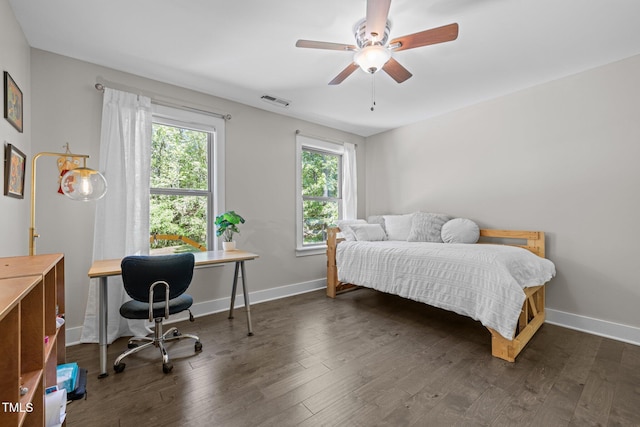bedroom featuring a ceiling fan, baseboards, visible vents, and dark wood-type flooring