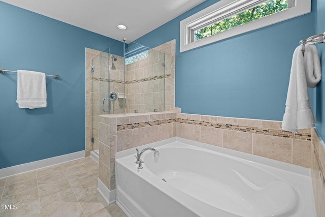full bathroom with baseboards, a shower stall, and a bath
