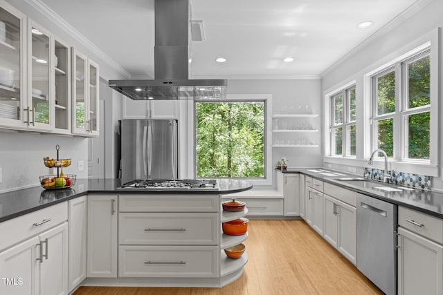kitchen featuring island exhaust hood, open shelves, appliances with stainless steel finishes, and crown molding