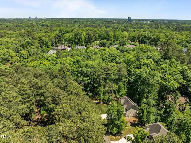 birds eye view of property featuring a view of trees