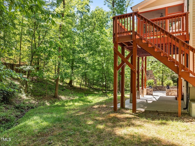 view of yard with stairs, a patio area, and a wooden deck