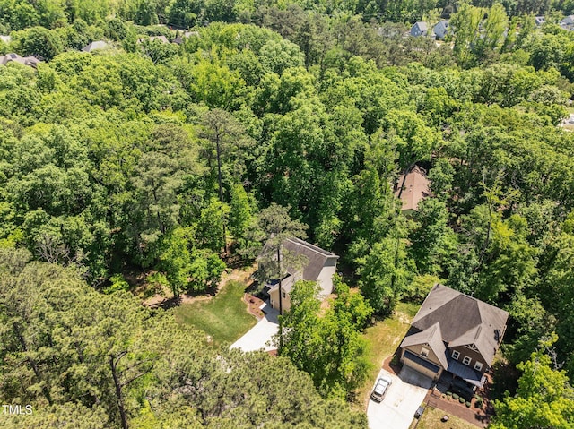 birds eye view of property featuring a view of trees