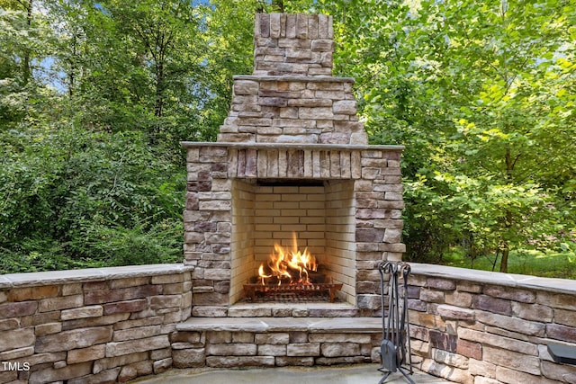 exterior space with an outdoor stone fireplace