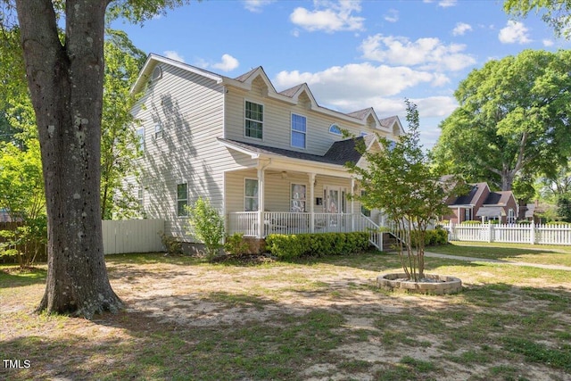 view of front of property with fence and a porch