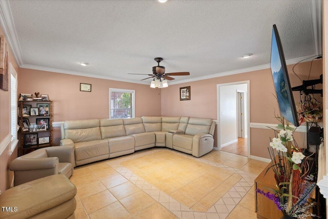living room with a ceiling fan, a textured ceiling, light tile patterned flooring, and ornamental molding