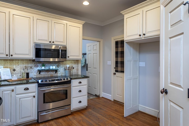 kitchen featuring ornamental molding, baseboards, dark wood finished floors, appliances with stainless steel finishes, and backsplash