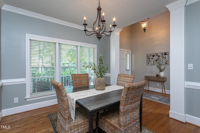 dining room with crown molding, baseboards, wood finished floors, and a notable chandelier