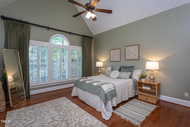 bedroom with ceiling fan, high vaulted ceiling, baseboards, and wood finished floors