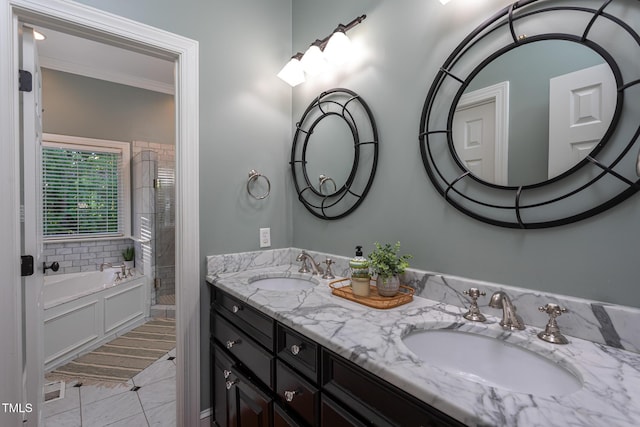 full bath with double vanity, a sink, a garden tub, and a shower stall