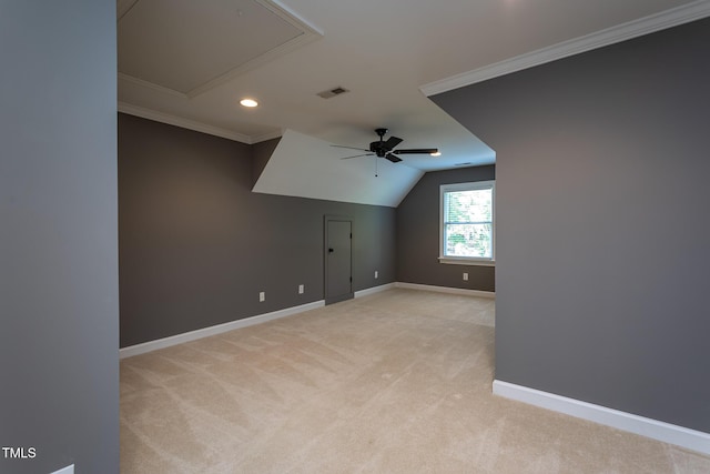 additional living space with a ceiling fan, attic access, visible vents, baseboards, and light carpet