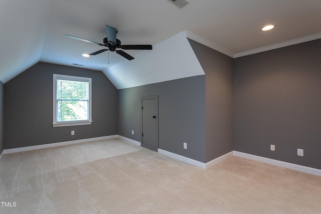 additional living space with baseboards, ceiling fan, light carpet, and vaulted ceiling