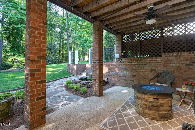 view of patio featuring ceiling fan and an outdoor fire pit