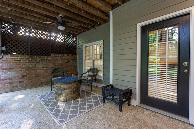 view of patio / terrace featuring a ceiling fan and an outdoor fire pit