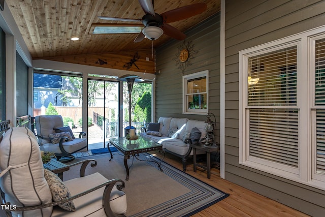 sunroom with wood ceiling, ceiling fan, an outdoor hangout area, and a wealth of natural light