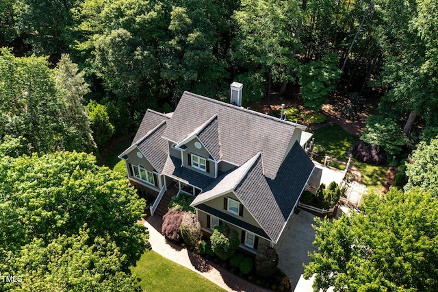 drone / aerial view with a wooded view