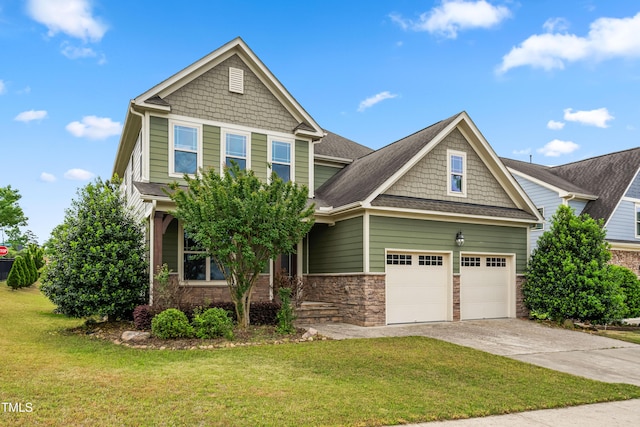 craftsman-style house with a shingled roof, stone siding, driveway, and a front yard