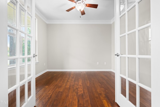 spare room featuring crown molding, baseboards, dark wood-style floors, and french doors
