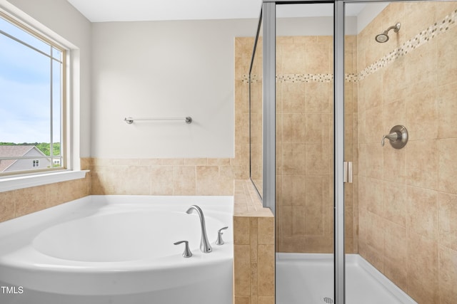 full bath with a shower stall and a garden tub