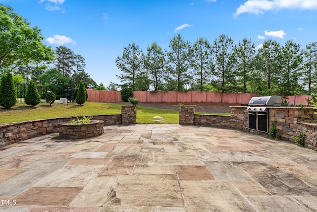 view of patio featuring area for grilling, a fenced backyard, and a grill