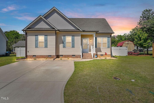 608 W Godwin St, Dunn, NC 28334 - bungalow with fence, roof with shingles, board and batten siding, crawl space, and a yard