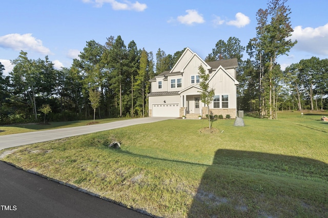 view of front of property with an attached garage, a standing seam roof, a front yard, and concrete driveway