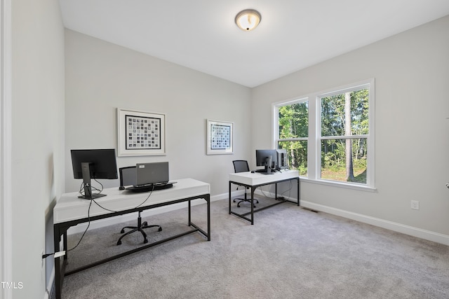 carpeted office space featuring baseboards and visible vents