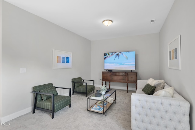 living area featuring visible vents, baseboards, and carpet floors