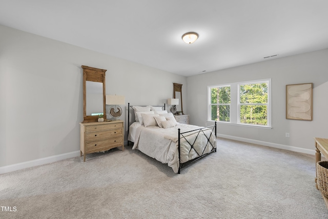 bedroom with baseboards, carpet floors, and visible vents