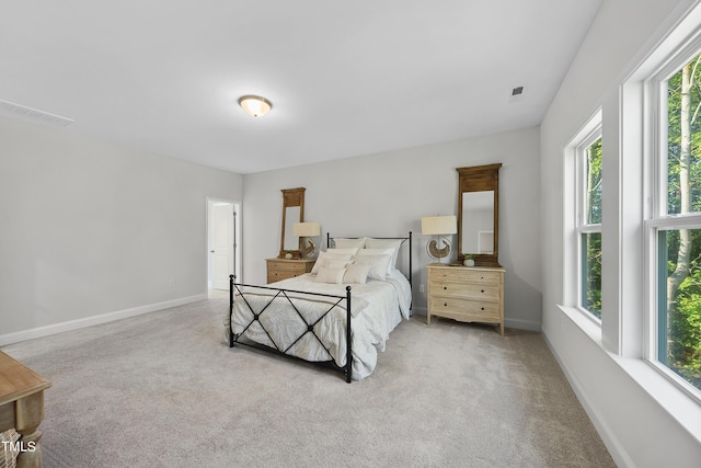 bedroom with baseboards, multiple windows, carpet flooring, and visible vents
