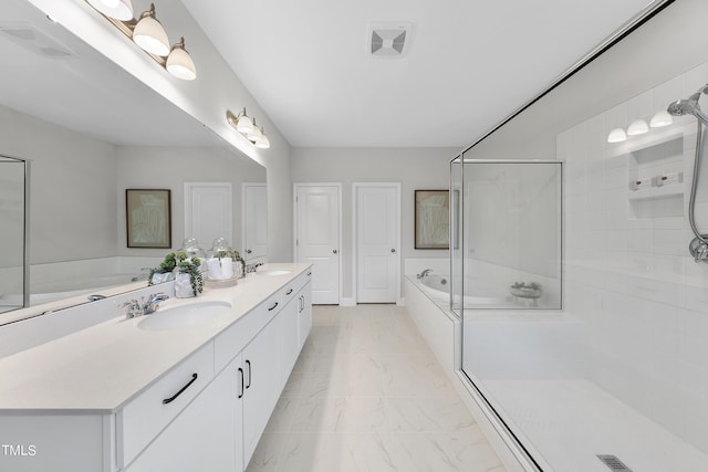 bathroom with a sink, visible vents, a garden tub, and marble finish floor
