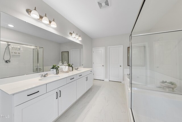 bathroom featuring a sink, marble finish floor, and a shower stall