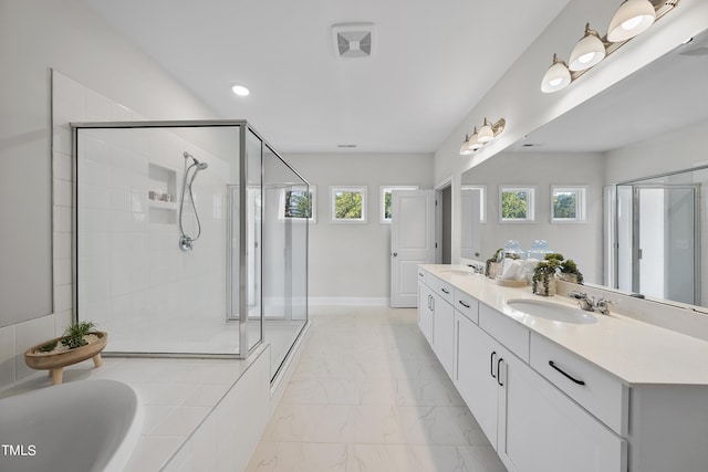 bathroom with a sink, a shower stall, and marble finish floor