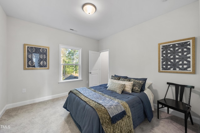 carpeted bedroom featuring baseboards and visible vents