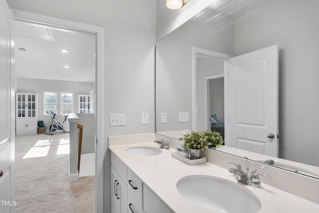 bathroom featuring a sink, recessed lighting, and double vanity