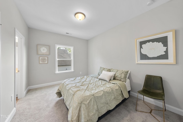 carpeted bedroom featuring baseboards and visible vents