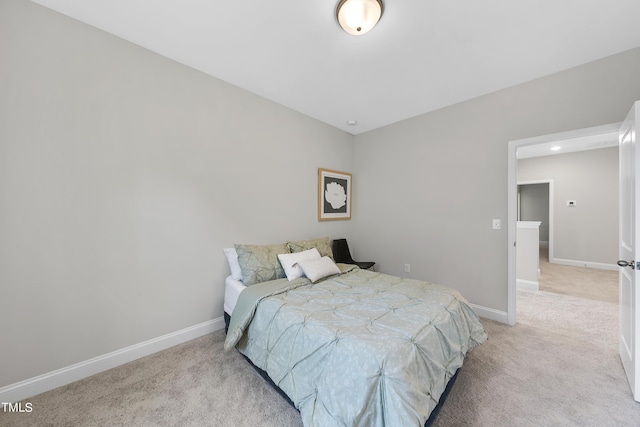 bedroom with baseboards and light carpet
