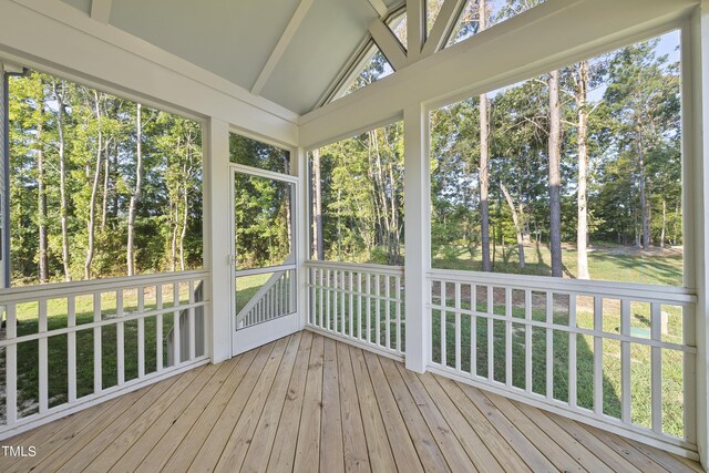 unfurnished sunroom featuring beamed ceiling