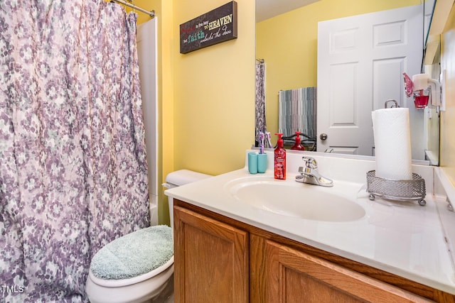 bathroom featuring toilet and vanity