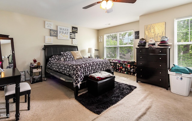 bedroom with multiple windows, carpet flooring, and a ceiling fan