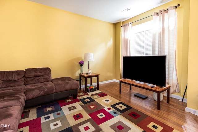living room with wood finished floors and baseboards