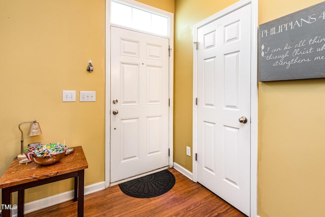 doorway to outside with wood finished floors and baseboards