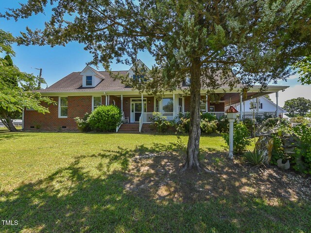 2371 NC-210, Smithfield, NC 27577 - view of front facade featuring crawl space, a porch, a front yard, brick siding, and a shingled roof