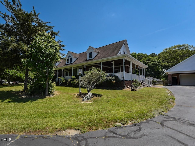 2371 NC-210, Smithfield, NC 27577 - view of front facade with a sunroom, a front lawn, and a detached garage